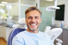 A Man Smiling In A Dentist Chair Created With Generative AI Technology