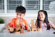 © sorapop - Children boy and girl playing with constructor wooden block building, Happy little kids play wood block stacking board game at home, activities learning creative, toys for preschool and kindergarten