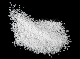 Wall Mural - Crystals of sea salt on a black background, top view. Pile of salt.