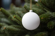 © AnaWein - Christmas white glossy round bauble ornament on christmas tree background.