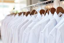 Fashionable White Shirts Hanging In Store