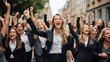 © Artofinnovation - Group of business woman in the streets happy and celebrating with their fists in the air, concept of female empowerment in the workforce