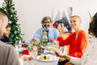 © Xavier Lorenzo - Multi generational group of happy family having christmas dinner at home
