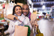 © JackF - Happy married couple with packages of gifts at new year street fair