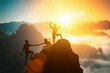 Silhouette friends helping each other and with teamwork, trying to reach top of the mountains during summer sunset, Business, success,victory,leadership,achievement concept. Freedom travel adventure.