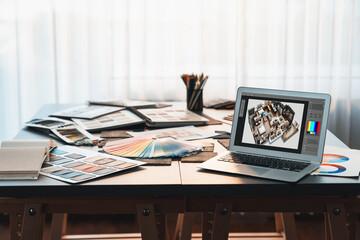 Interior designer workspace table and architecture software on laptop screen with mood board materials and colorful swatch color for color selection. Modern interior design office. Insight