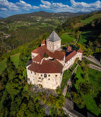 Wall Mural - Val Isarco, Italy - Aerial panoramic view of Trostburg Castle (Castel Trostburg), a XII century fortress at the Italian Dolomites on a sunny summer day with green foliage and blue sky with clouds
