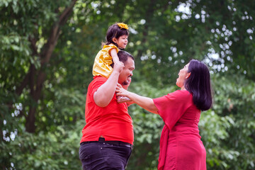 Wall Mural - Happy asian family in the garden