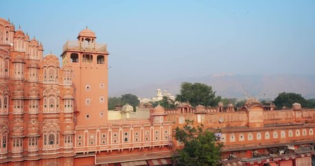 Wall Mural - Famous Indian tourist landmark Hawa Mahal or Palace of the Winds in Jaipur city, Rajasthan, India. Hawa Mahal is an embodiment of Rajputana architecture. Camera horizontal panning