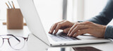 Fototapeta Uliczki - Man hands typing on computer keyboard closeup, businessman or student using laptop at home, panoramic banner, online learning, internet marketing, working from home, office workplace freelance concept