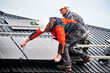 © anatoliy_gleb - Builders installing photovoltaic solar panels on roof of house. Men engineers in helmets building solar module system with help of hex key. Concept of alternative, renewable energy.
