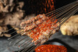 Indoor BBQ meat skewers, paprika and charcoal fire