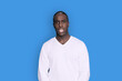 © Rafa Fernandez - Portrait of cheerful young african-american guy wearing white casual sweater posing isolated on blue background