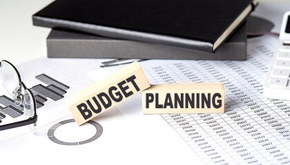 Poster - BUDGET PLANNING - text on a wooden block with chart and notebook