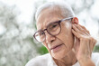 © Satjawat - Old elderly woman experiencing ear pain,Swimmer's Ear,Perforated eardrums caused by trauma or infection,painful and discomfort in the ear canal,illness,health problems,lifestyle,health care concept