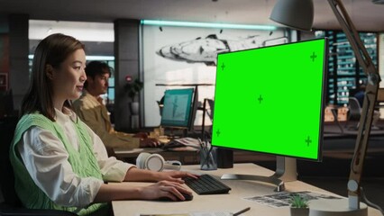 Poster - Portrait of Asian Woman Sitting at Her Desk Using Desktop Computer with Mock-up Green Screen Chromakey. Female Concept Artist Working in Game Development Studio Office, Creating Immersive Gameplay.