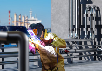Poster - Male welder. Repair of pipes in port. Pipeline near cargo harbor. Welder in mask near ship. Repair of pipes using soldering machine. Welder at work. Installation of fuel pipes in port