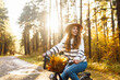 Happy young woman riding a bike, having fun in the autumn park. Concept of relaxation, nature. Active lifestyle.