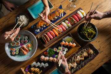 Wall Mural - Unrecognizable people eating traditional Asian food