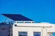 © Voyagerix - Caravan with tilt solar panels on roof.