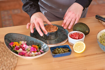 Wall Mural - Chef preparing tartar at table in kitchen