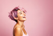 © sinseeho - Woman with short sassy purple color hair, laughing away. On pink background, copy space.