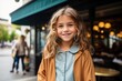 © Learoy - Portrait of cute little girl smiling at camera while standing in cafe