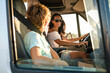 © ADDICTIVE STOCK CORE - Woman with kid enjoying summer vacation in camper car