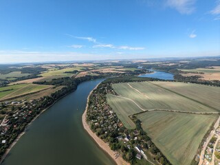 The Hracholusky concrete dam with water power plant.water reservoir on the river Mze. Source of renewable energy and popular recreational area in Bohemia. Czech Republic, Europe.aerial, green water
