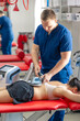 © puhimec - Electromagnetic therapy of the back, physiotherapist doctor uses medical equipment.