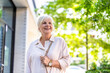 © pikselstock - Portrait of happy senior woman standing in the city