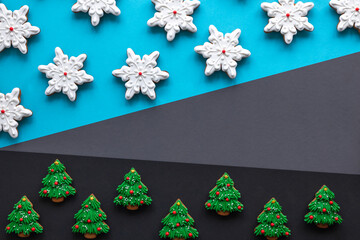 Wall Mural - Christmas gingerbread covered with icing on a colored background, flat lay.