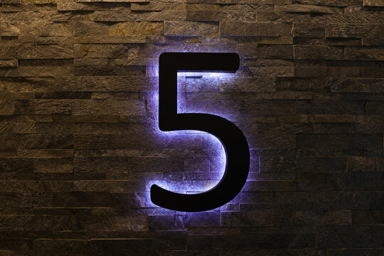 Dark  Neon Font with fluorescent purple tubes  Number 5 on the dark brown brick wall.  Night Show Alphabet.
