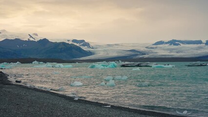 Wall Mural - Sunset over natural iceberg in Jokulsarlon glacier lagoon at Iceland