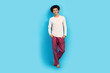 Full size photo of cute young guy posing hands pockets shopping wear trendy white pajama outfit isolated on blue color background