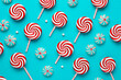 Creative minimal Christmas art. Pattern made with Christmas candies on bright blue background. Flat lay. Copy space. Minimal composition