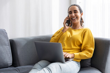 University teen girl or hispanic indian business woman sitting relax on sofa happy enjoy with modern technology device working at home