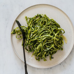 Wall Mural - Plate of linguine pasta with greens and Parmesan cheese, healthy vegetarian meal, close up