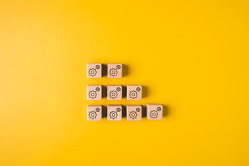 Setting and gear icon on wooden blocks for planning management and development, Business target, Technical support, Setting business goal