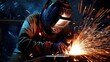 © cherezoff - A masked welder welds parts