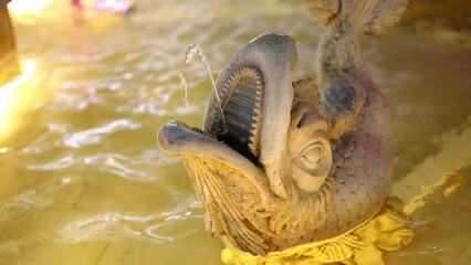 Poster - fountain with stone fish from the mouth of a stream of water.