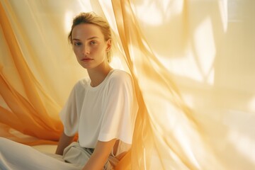 Wall Mural - Woman sitting near white curtain