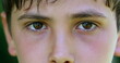 Serious child boy face eyes macro closeup looking to camera