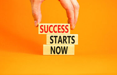 Success starts now symbol. Concept word Success starts now on beautiful wooden block. Businessman hand. Beautiful orange table background. Business motivational success starts now concept. Copy space.
