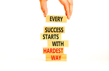 Wall Mural - Success symbol. Concept words Every success starts with hardest way on wooden block. Beautiful white table white background. Businessman hand. Business success and hardest way concept. Copy space.