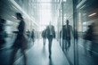 © sommersby - Motion blur view of large lobby with glass walls in a corporate building with people in formal suits moving by pressing business.