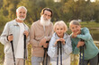 © New Africa - Senior men and women with Nordic walking poles outdoors