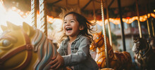 Cheerful Little Asian American Girl On Carousel