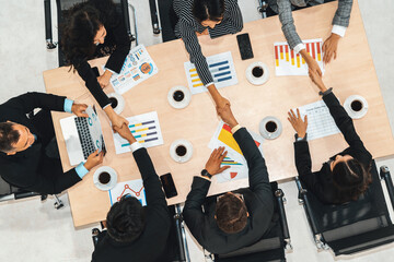 Wall Mural - Group business people handshake at meeting table in office together with confident shot from top view . Young businessman and businesswoman workers express agreement of investment deal. Jivy