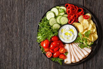 Wall Mural - ham, chips, leafy greens, veggies snack platter